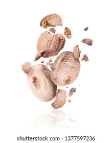 Nutmeg Crushed Into Pieces, Frozen In The Air On A White Background