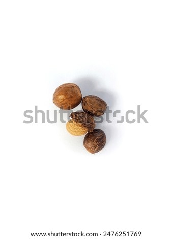 Nutmeg in Nutmeg Shell on white Background - Isolated. Top view