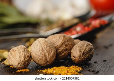 Nutmeg spice on dark wooden table close up - Powered by Shutterstock