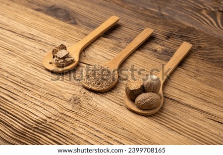 Nutmeg in Wood Spoon, Myristica Fragrans Fruit, Dry Spicy Nutmeg, Grated Whole Muscat Nut, Nut Meg Seasoning, Fragrans Nutty Spices on Wooden Rustic Background