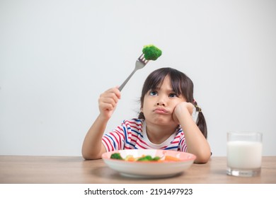 Nutrition healthy eating habits for kids concept. Children do not like to eat vegetables. Little cute girl refuses to eat healthy vegetables. - Shutterstock ID 2191497923