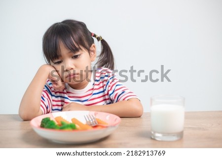 Nutrition healthy eating habits for kids concept. Children do not like to eat vegetables. Little cute girl refuses to eat healthy vegetables.