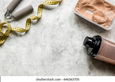 Nutrition For Workout With Protein Cocktail Powder, Measure Tape And Bars On Stone Background Top View Mockup