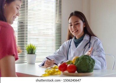 Nutritional. Friendly Nutritionist Female Doctor Medical Smiling And Discussing About Diet Plan With Vegetable To Young Patient In Office Hospital, Nutrition, Food Science, Healthy Food Concept