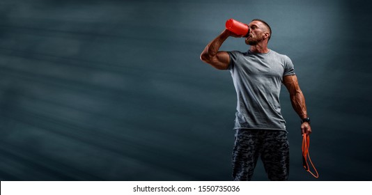 Nutritional Supplement. Muscular Men Drinks Protein, Energy Drink After Workout