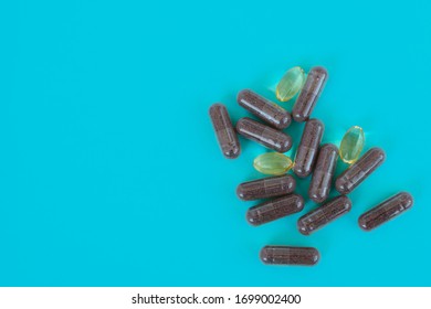 Nutritional Supplements. Herbal Medicine Capsules And Vitamin E Capsules On A Blue Background. Omega Capsules. Vitamin Pill. Top View. Flatlay. Copyspaсe For Text. 
Selective Focus.