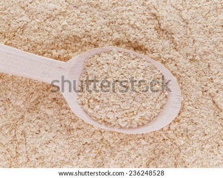 Nutritional yeast (deactivated yeast) in wooden spoon
