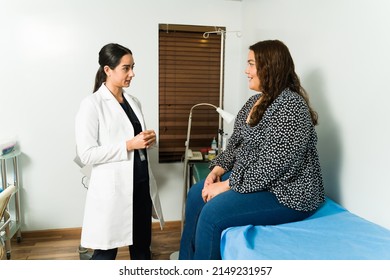 Nutritionist Doctor Speaking To An Obese Female Patient About Losing Weight To Prevent Health Problems