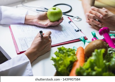 Nutritionist giving consultation to patient with healthy fruit and vegetable, Right nutrition and diet concept - Shutterstock ID 1439907584