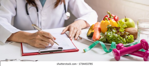 Nutritionist giving consultation to patient with healthy fruit and vegetable, Right nutrition and diet concept - Shutterstock ID 1734453785