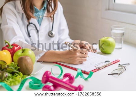 Nutritionist giving consultation to patient with healthy fruit and vegetable, Right nutrition and diet concept