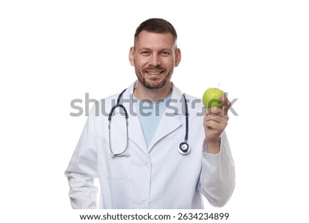 Nutritionist with green apple and stethoscope on white background