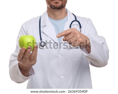 Nutritionist with green apple and stethoscope on white background, closeup