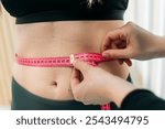 Nutritionist measuring woman