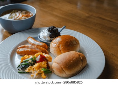 Nutritious breakfast combination of bread rolls, sausages and fresh soup