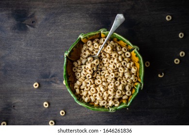 nutritious cereal cornflakes breakfast on the wooden table with honey and milk