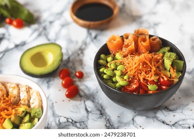 Nutritious poke bowl with avocado, edamame, cherry tomatoes, shredded carrots, shrimps and salmon on a marble background. Healthy food concept - Powered by Shutterstock