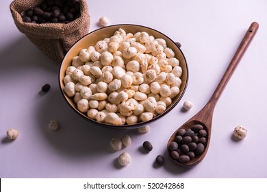 Nutritious roasted Makhana Namkeen or Fox Seed, which is a part of Lotus Flower. Served in a bowl over colourful or wooden background. Selective focus