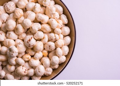 Nutritious roasted Makhana Namkeen or Fox Seed, which is a part of Lotus Flower. Served in a bowl over colourful or wooden background. Selective focus