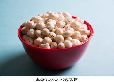 Nutritious roasted Makhana Namkeen or Fox Seed, which is a part of Lotus Flower. Served in a bowl over colourful or wooden background. Selective focus
