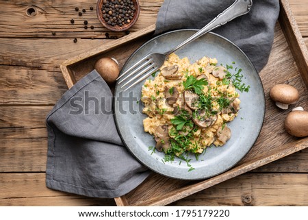 Nutritious scrambled eggs with mushrooms, onion and parsley for breakfast