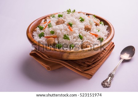Nutritious Soybean pulao/Pilaf or Soya chunk fried Rice with green peas and beans. Served in a bowl over colourful or wooden background. Selective focus