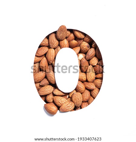 Nuts almonds typeface. Number zero made of nut heap and paper cut null shape isolated on white