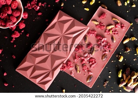 Nuts and berry with ruby chocolate bars, pieces and chunks