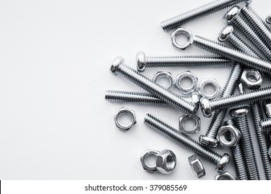 Nuts and bolts closeup on white background - Shutterstock ID 379085569