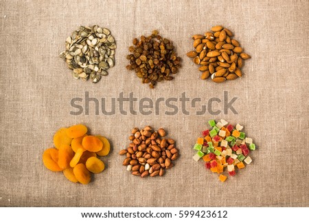 nuts and dried fruit in circles on a white background
