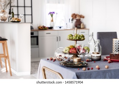 Nuts, Grapes And Apples On Dining Table With Wine Glasses And Plate With Tableware