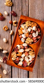 Nuts Mixed in a wooden plate.Assortment, Walnuts,Pecan,Almonds,Hazelnuts,Cashews,Pistachios.Concept of Healthy Eating.Vegetarian.selective focus. - Shutterstock ID 583690000