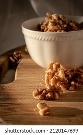 Nuts In White Tea Cup On Wooden Chopper