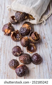 Nutshells Of Soapnuts In A Cotton Bag For Laundry On A White Wood