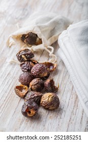 Nutshells Of Soapnuts In A Cotton Bag For Laundry On A White Wood