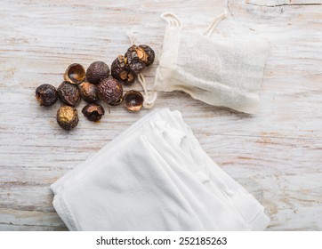 Nutshells Of Soapnuts In A Cotton Bag For Laundry On A White Wood