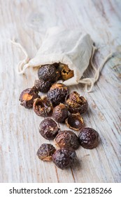 Nutshells Of Soapnuts In A Cotton Bag For Laundry On A White Wood