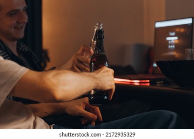 NY - 4 July,2022-Friend Brother, Men Hanging Out Together Looking At Screen Laptop Drinking Glass Bottle Beer Talking At Home In Late Evening. Movie Guys Night.Freelancer Having Fun In Apartment Work