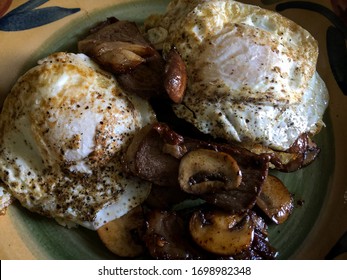 NY Strip Steak With Eggs Over Easy And Sautéed Mushrooms.