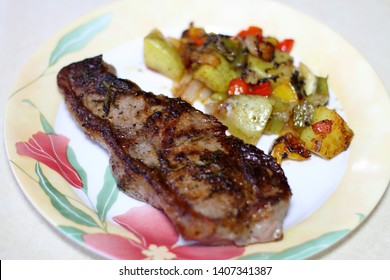 NY Strip Steak With Potatoes On A Plate.