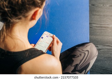 NY, USA - 2 May,2022-young Fitness Woman Phone Online Application Track Menstrual Cycle. Sport At PMS Critical Days Concept. Female Health Care, Gynecological Concept. Ovulation Calendar On Mobile App