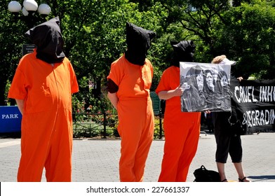NYC - June 15, 2012:  Amnesty International demonstrators wearing orange jumpsuits and black hoods urge an end to worldwide torture by staging a demonstration in NYC's Union Square