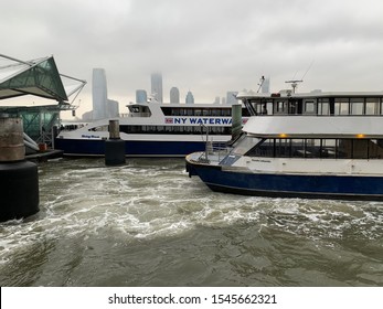 NYC, New York / USA-October 29 2019 : New York waterway ferry boats on the Hudson River. Other side is New Jersey. New Jersey is a state in the Mid-Atlantic region of the United States.