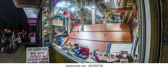 
NYC Pawn Shop Window At Night Storefront With Jewelry In A Poor Neighborhood, New York, Bronx, Lydik Avenue, 10462, United States Of America, 10.13.2021