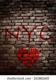 NYC spray painted on a grunge brick wall with a red heart                             