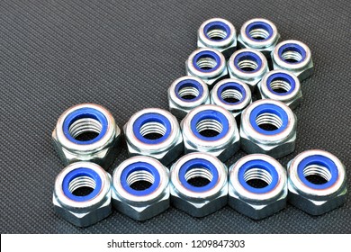Nylon lock nuts on dark background. Copy space.