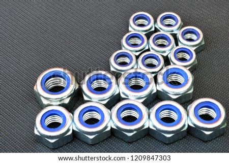 Nylon lock nuts on dark background. Copy space.