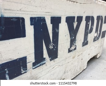 NYPD New York Police Department concrete barricade blocks in Manhattan, New York City. Used to block traffic, pedestrians, crowds.