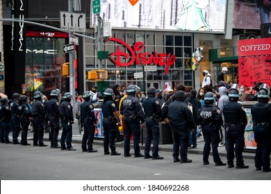 NYPD Officers Wearing Riot Gear Form A Protective Line Near The Disney Store During A Pro-Trump Rally And Protest In Times Square On October 25, 2020, In New York City. 