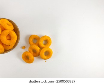 O ring snack with cheese flavor on mini wooden bowl isolated on white background. ring shaped snack with cheese flavor. - Powered by Shutterstock